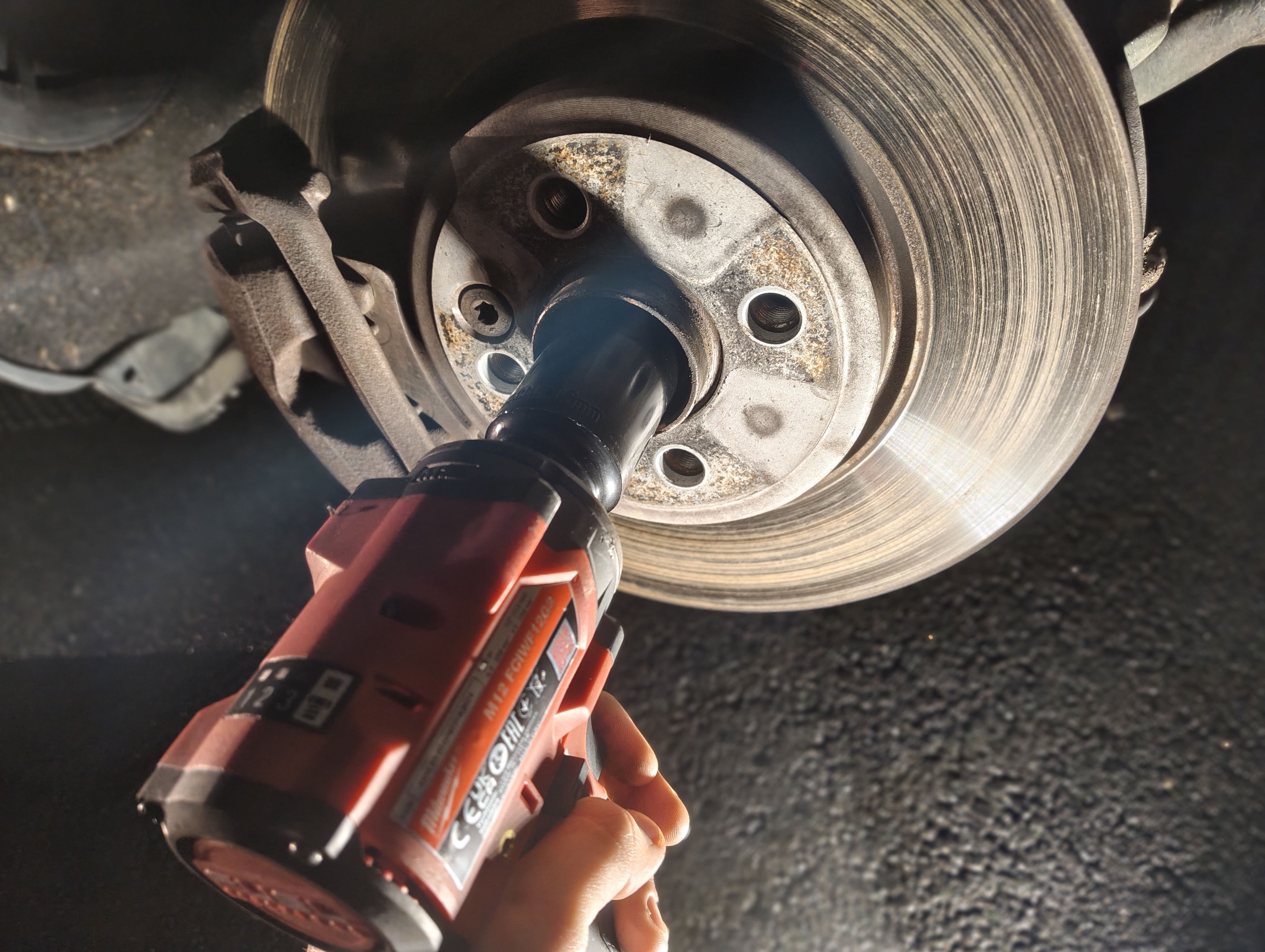 Removing the front passenger-side driveshaft nut